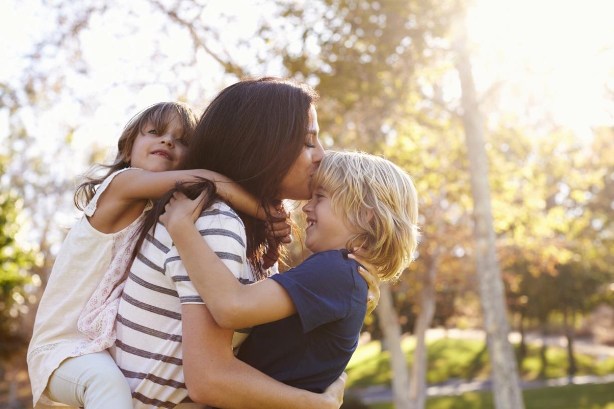 A mother holding her children 