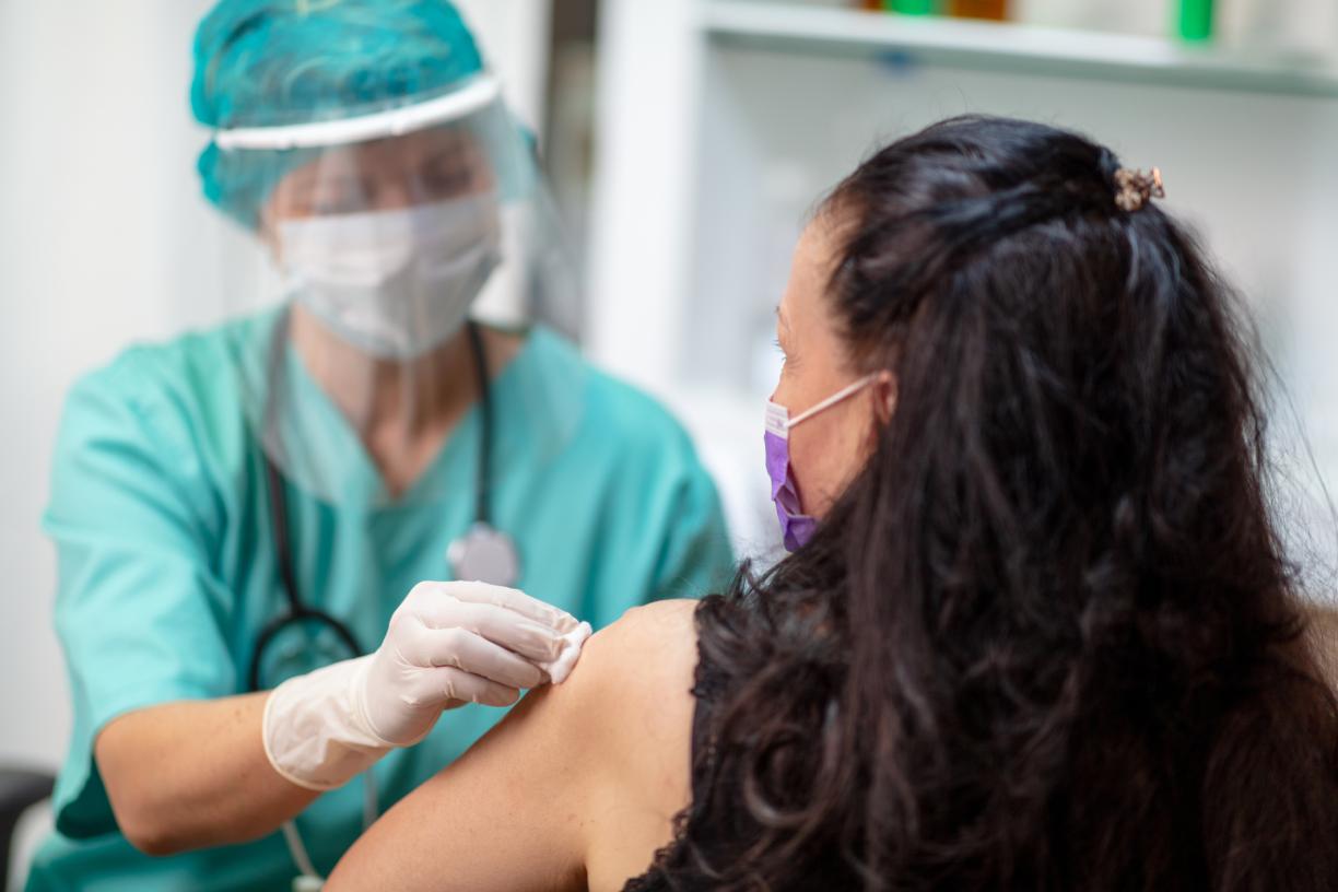 Doctor giving COVID-19 vaccine to patient 