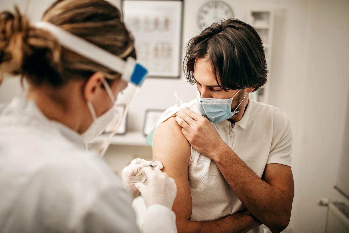 Young man getting COVID-19 vaccine