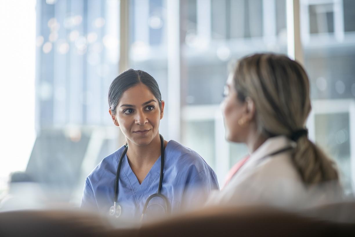 Physician speaking to coworker 