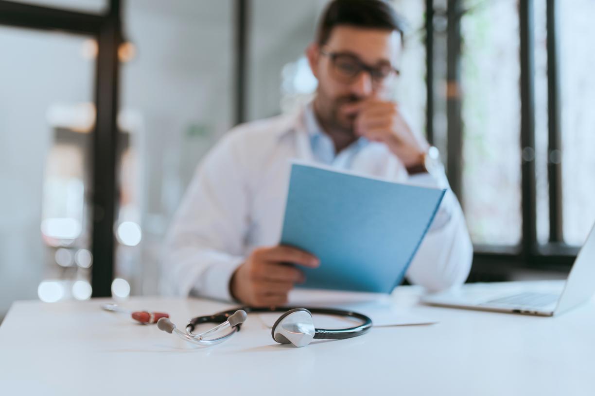 physician_blurry_out_of_focus_at_desk_stethoscope_patient_file_stock_photography_id_324420.jpg
