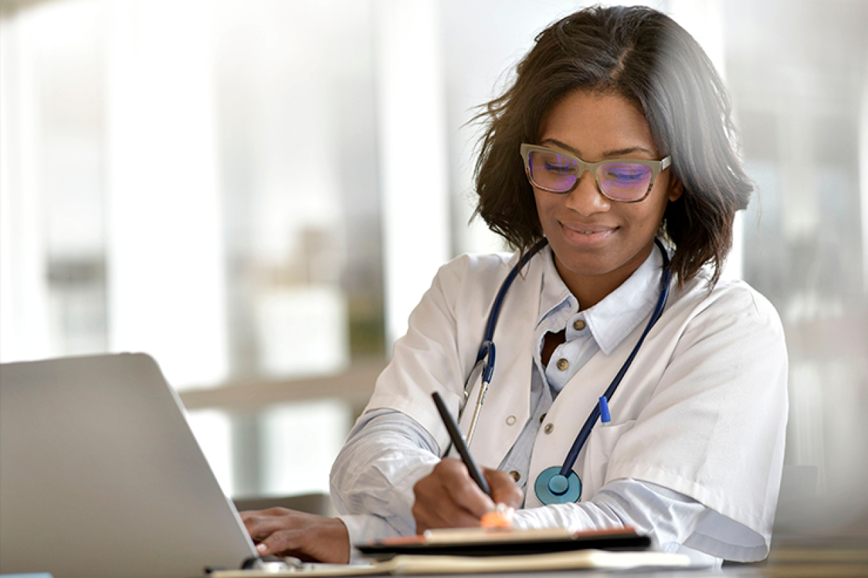 doctor_doing_paperwork_at_desk.png