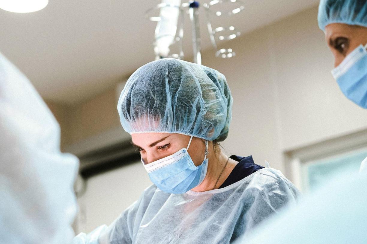 Three surgeons operating on a patient in the OR. 