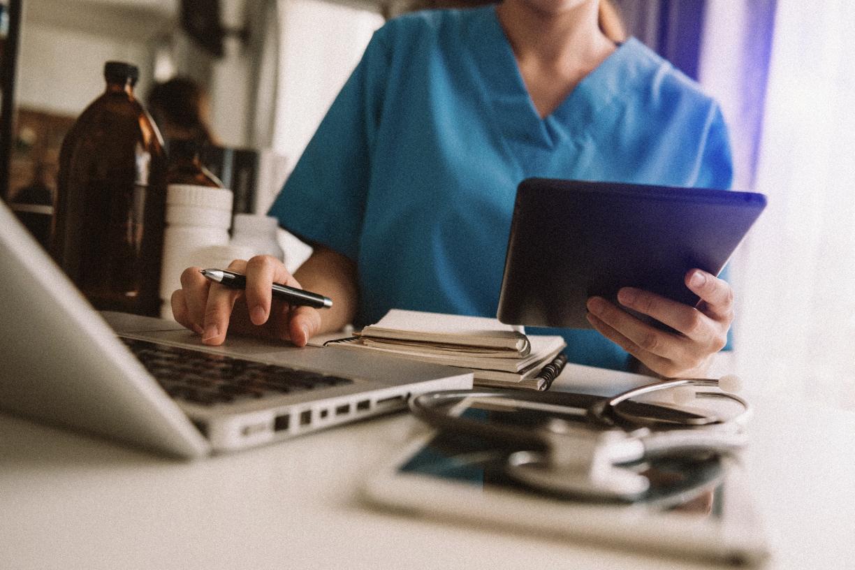 close_up_doctor_on_laptop_with_ipad_adobestock_332813141.jpg