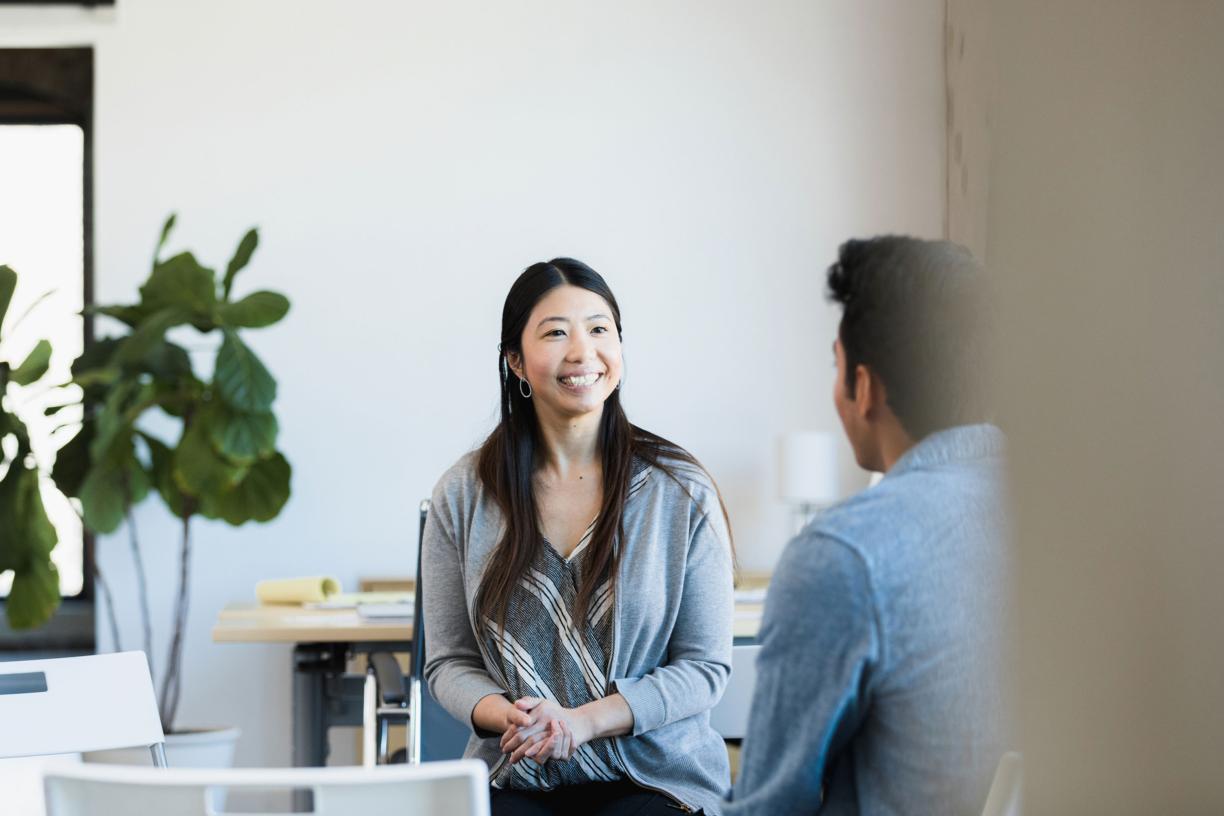 woman speaking with a health care colleague