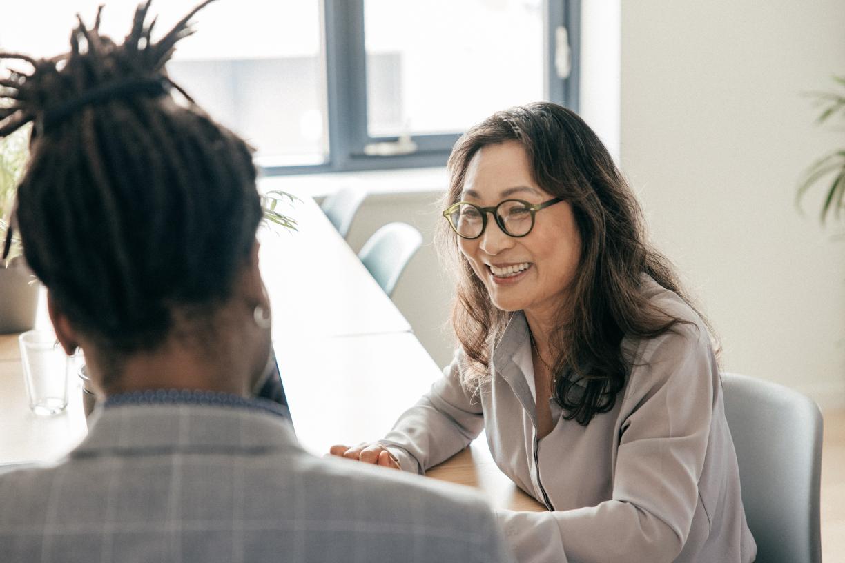 Woman talking to colleague in a board room.