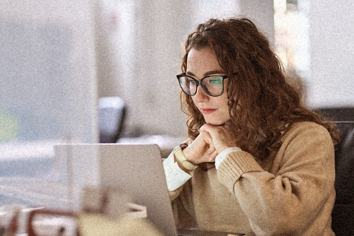 Young woman watching laptop.