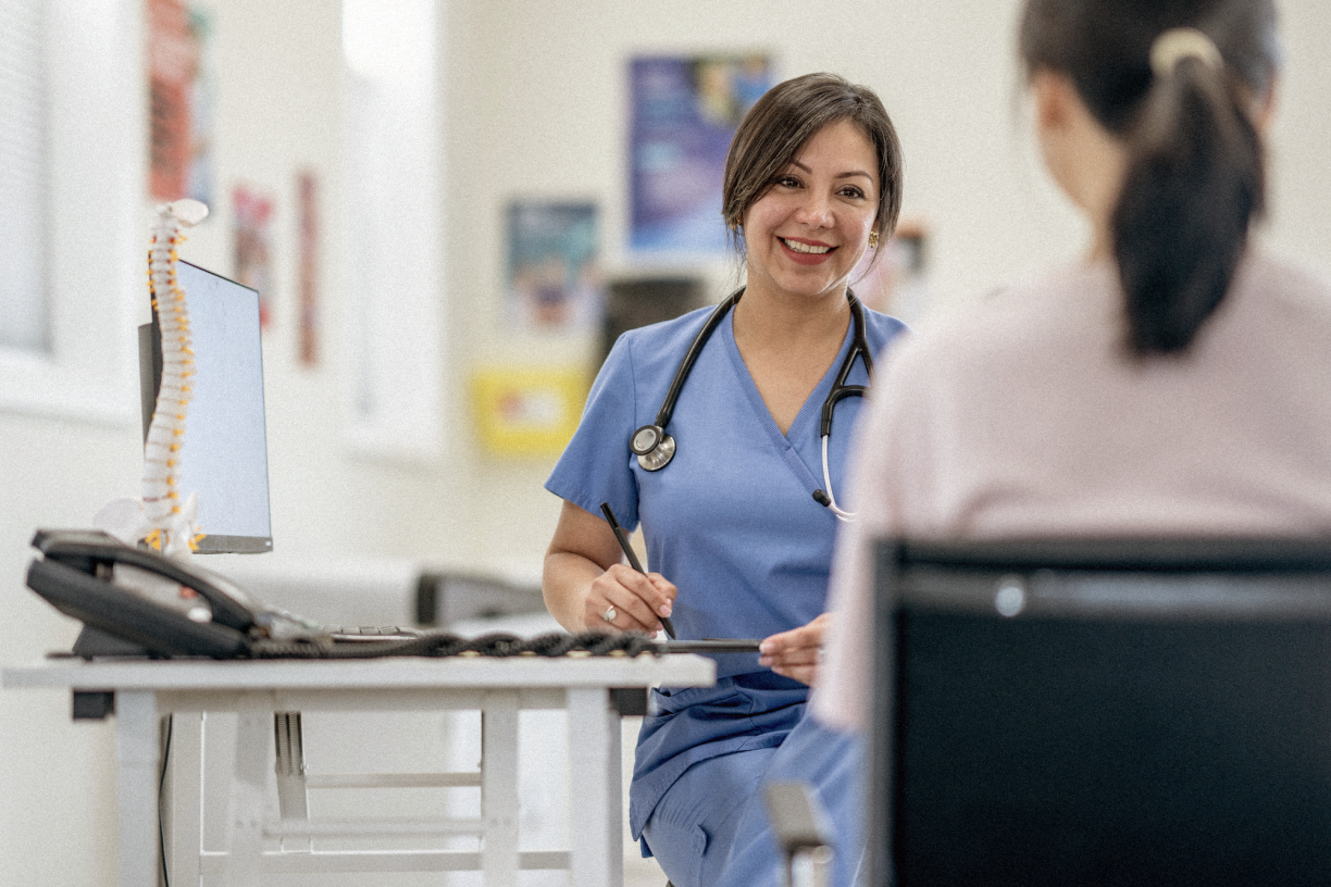 Doctors smiling talking to patient.