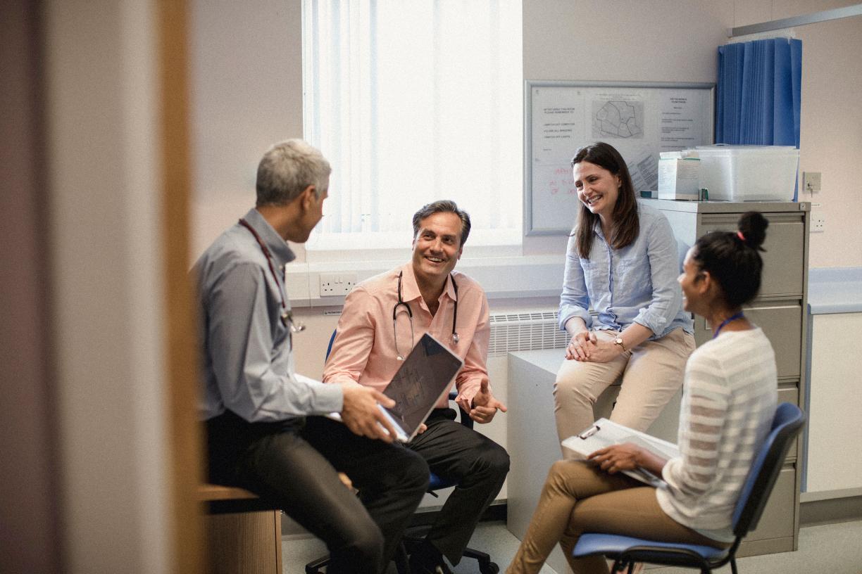A group of family doctors conversing in a clinical setting