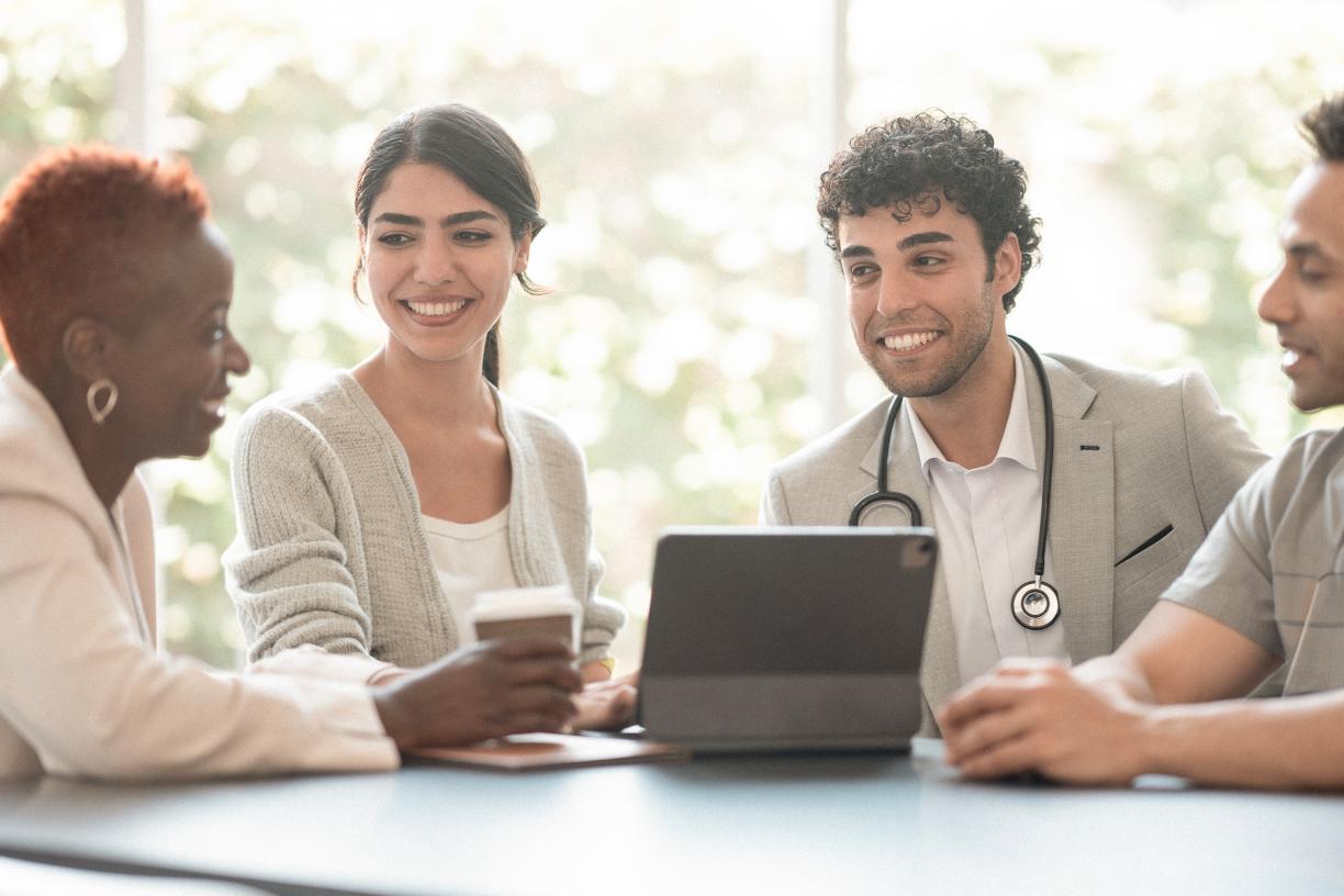 Physician leaders gathered at a table.
