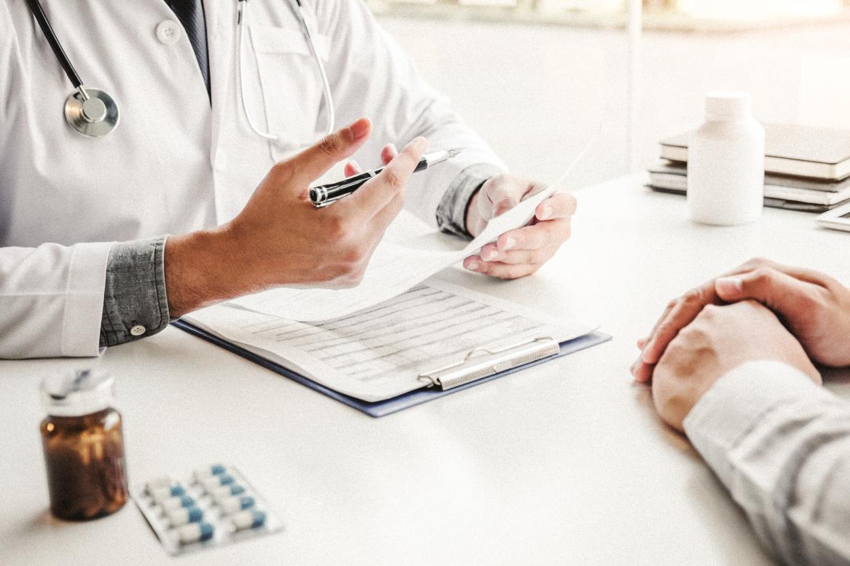 Doctor prescribing medication to patient.