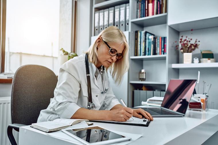 Female doctor writing notes 